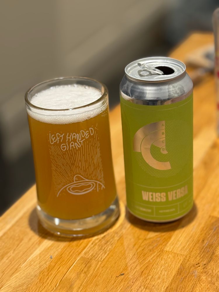A glass of Good Chemistry’s Weiss Versa next to its can