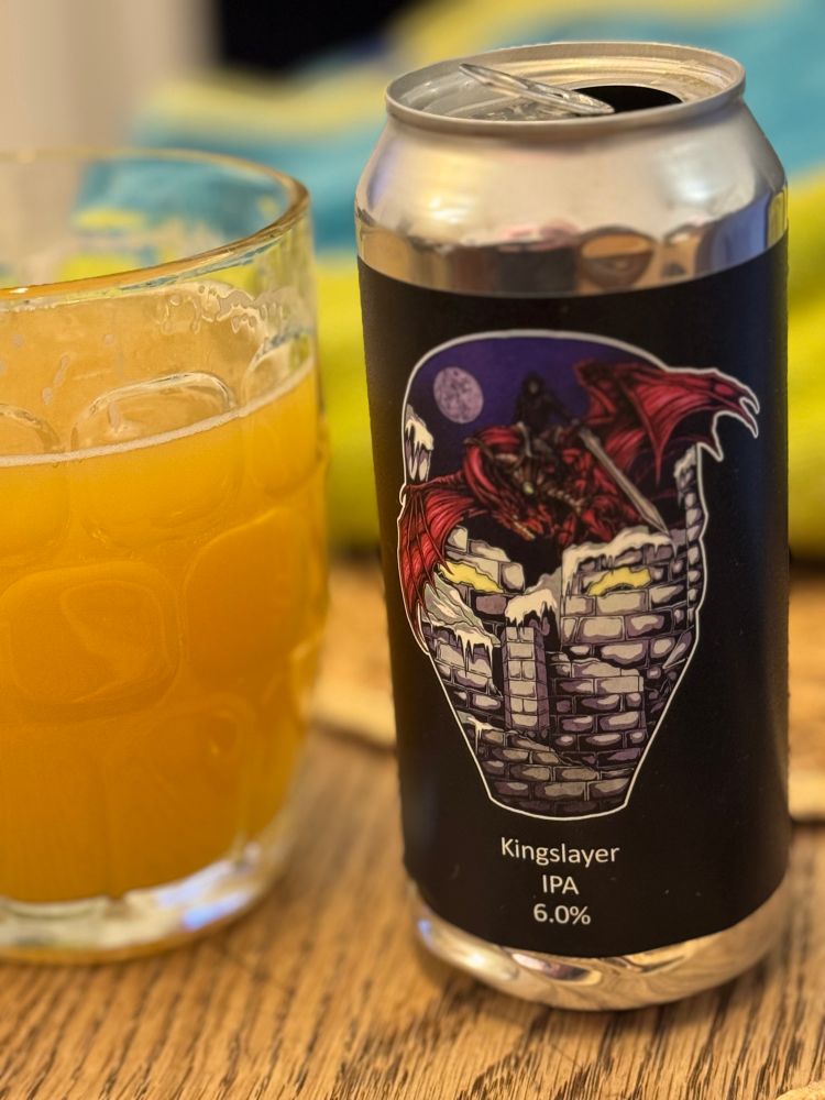A glass of Kingslayer IPA with its can