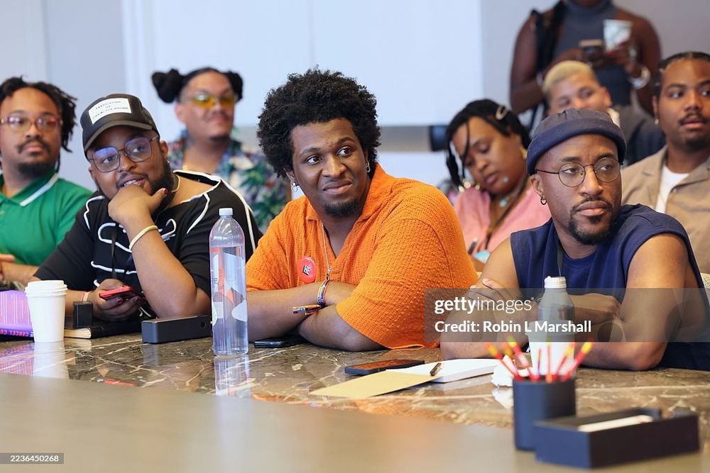 Three fine Black folk sitting side by side during a meeting.