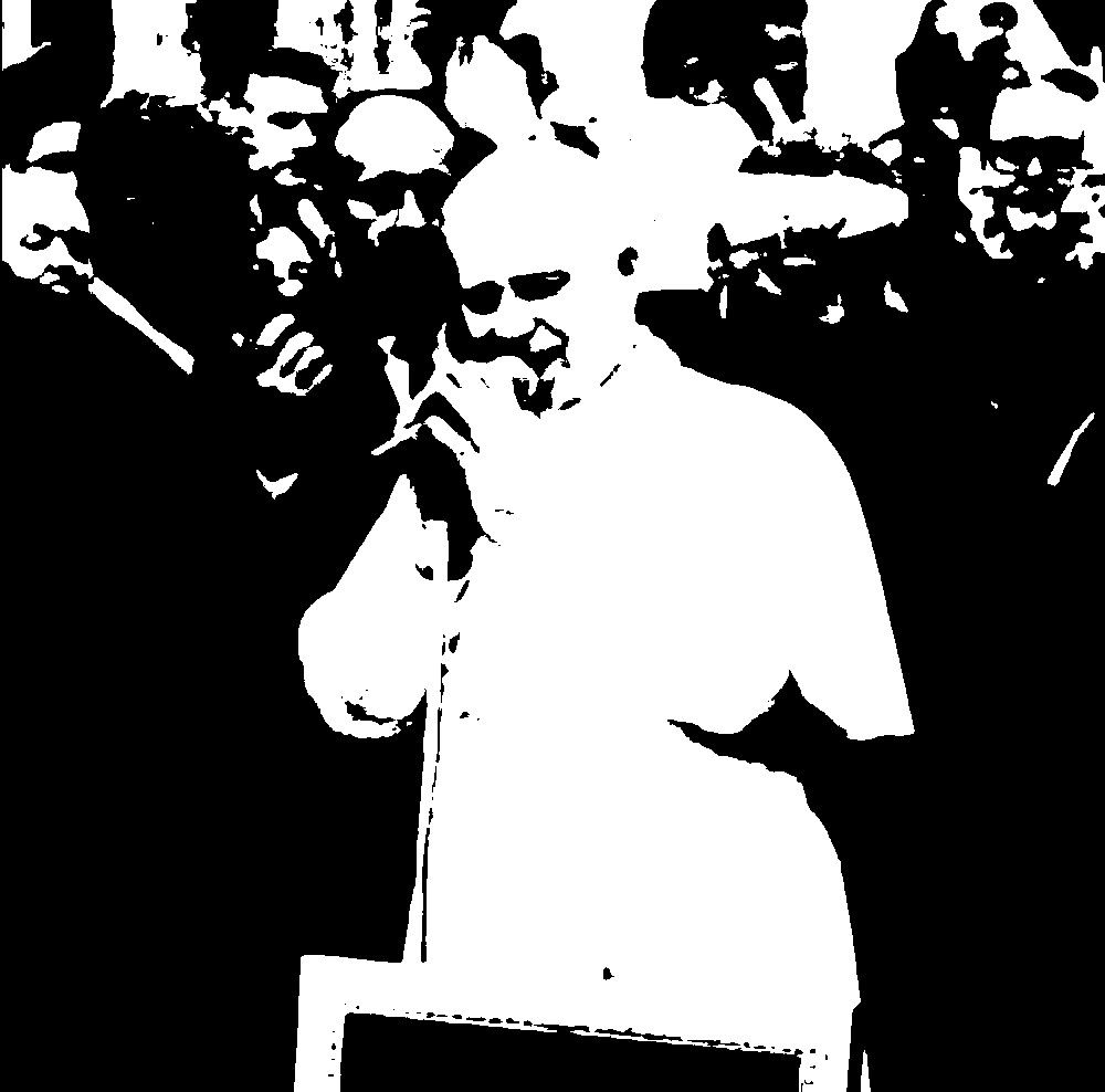Black and white image of Pope Francis at the mike.