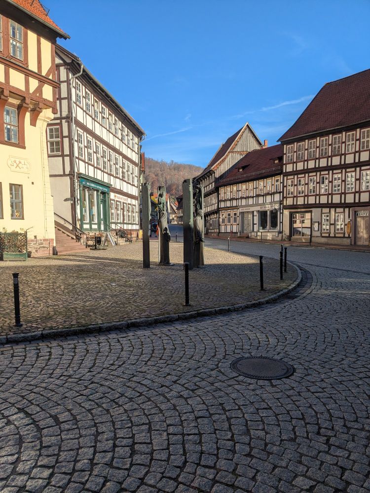 A little square surrounded by half-timbered houses, with cobblestones on the street