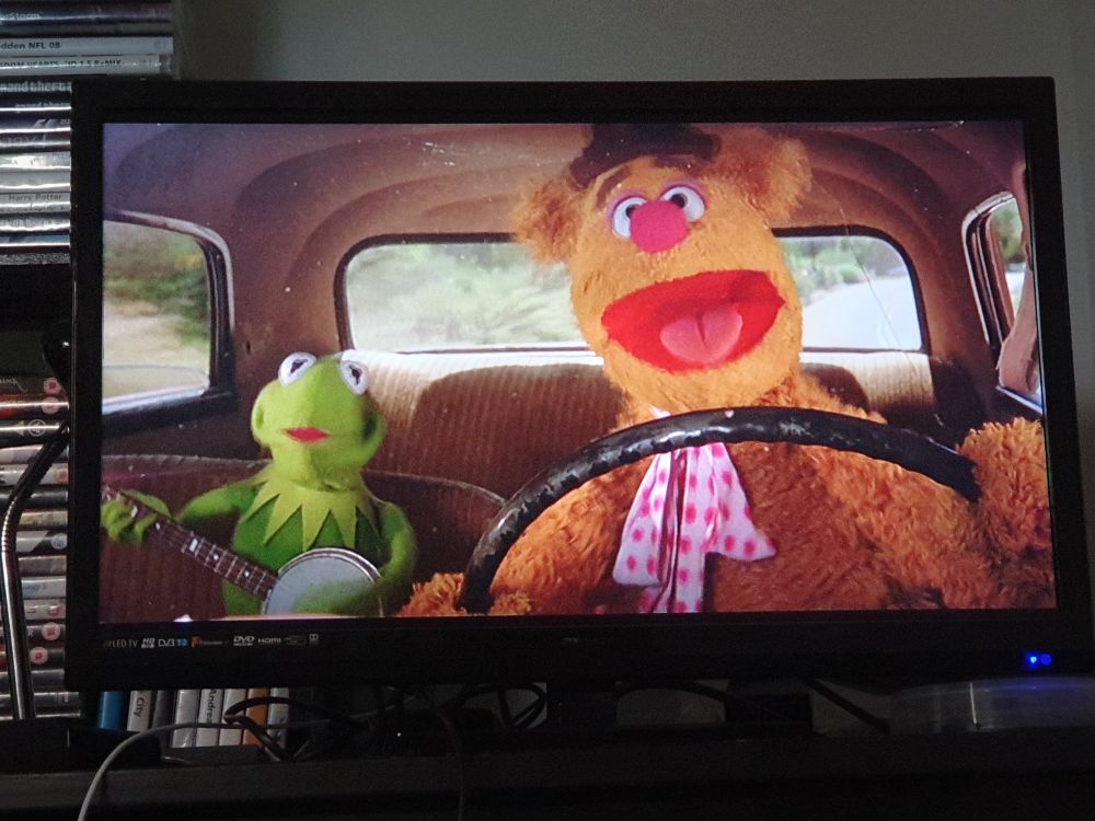 Photo of my TV displaying The Muppet Movie (1979). It's a frame from the Moving Right Along musical number.