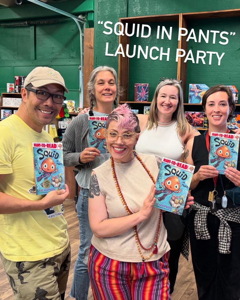 4 white women and one Asian man holding up book with illustration of Squid in Pants