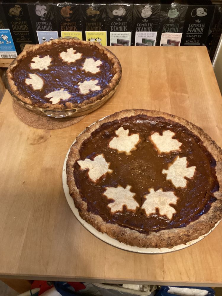 2 (overcooked) pumpkin pies with maple leaf decoration