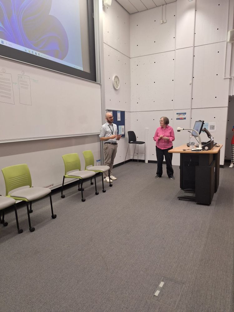 In the picture I am standing in front of the podium in a lecture hall, together with another presenter in the panel