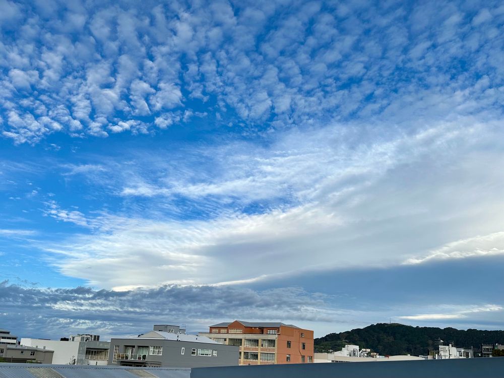 Skies over Te Aro streetscape, with a ragged mixture of altocumulus and other cloud layers.