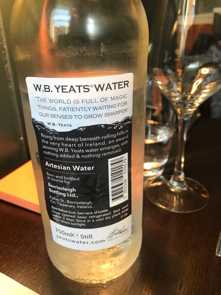 A glass bottle of water, labeled “W.B. Yeats Water”