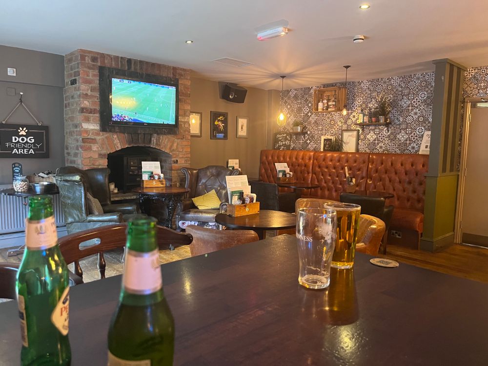 The interior of an empty pub. The England v Italy women’s euros game is on the TV