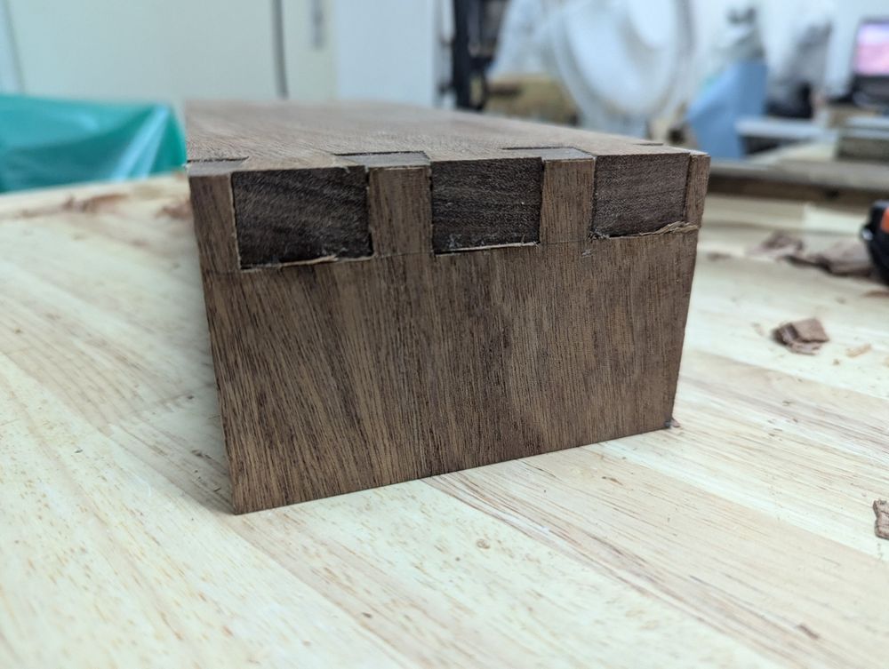 Closeup of one side of dovetails, showing my attempt at stuffing the gaps with shavings.
