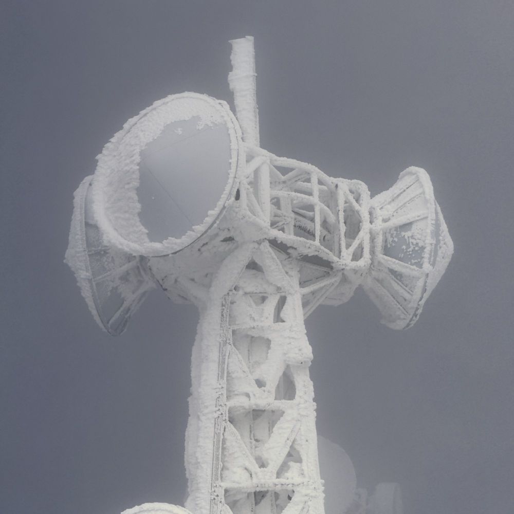 厳冬の横手山にそびえ立つ電波塔。雪と氷に覆われた構造が、幻想的で彫刻のような美しさを醸し出している。
A radio tower standing tall on Yokote Mountain in midwinter, covered in snow and ice, resembling a surreal and sculptural masterpiece.