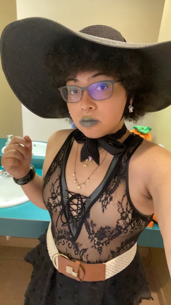 me weaing a wide sunhat, lace bodysuit, and long ruffled skirt