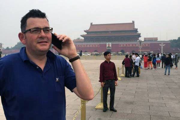 Dan Andrews taking a call in China - used for many great memes