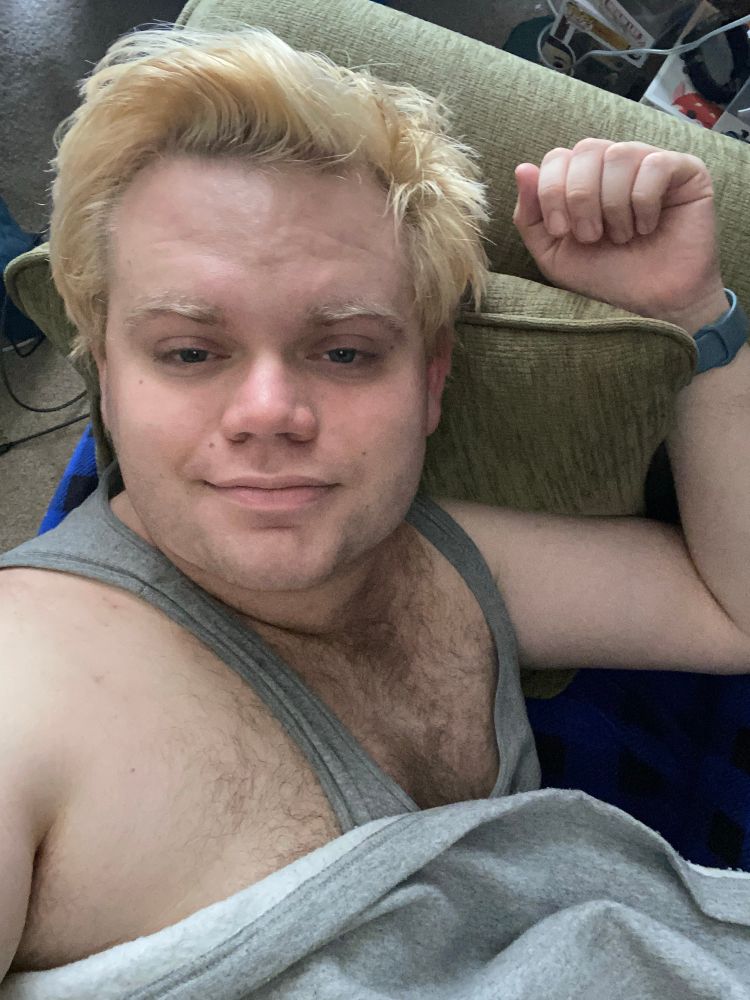 Selfie of a sleepy blond man with a lot of chest hair exposed