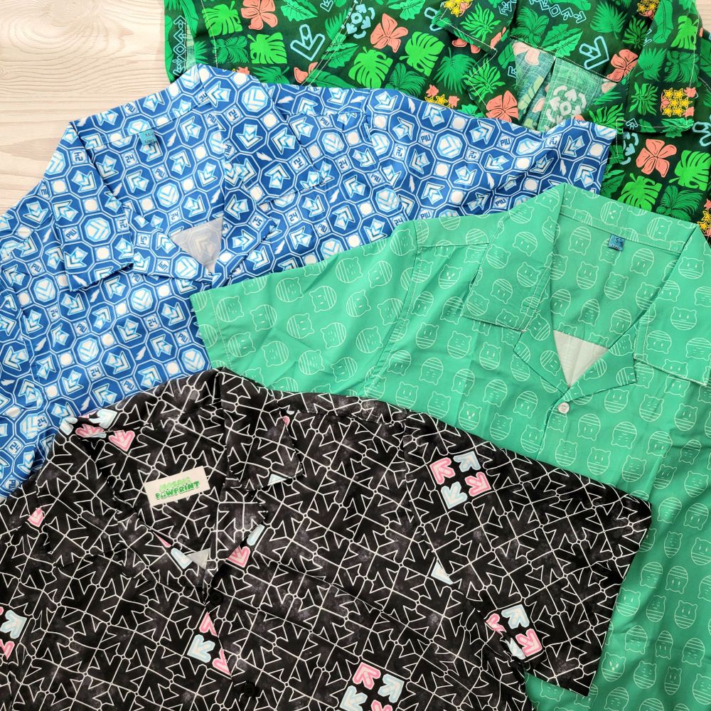 Flat lay display of several button-up shirts featuring patterns from a variety of music games.