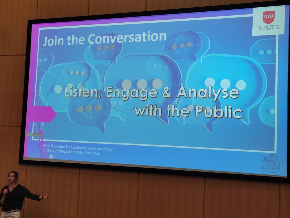 Dr Keeley Brookes enthusiastically introducing a colourful slide "Join the conversation. Listen, engage and analyse with the public" 
