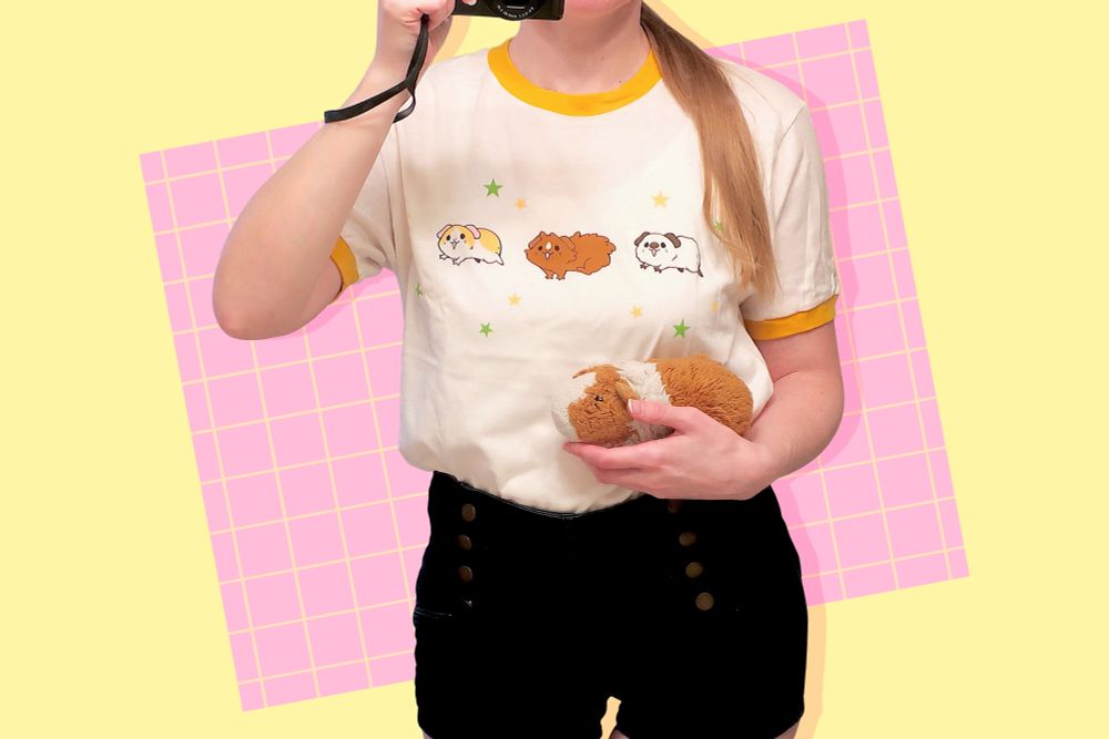 A yellow/off-white ringer tee featuring three guinea pigs running in a line