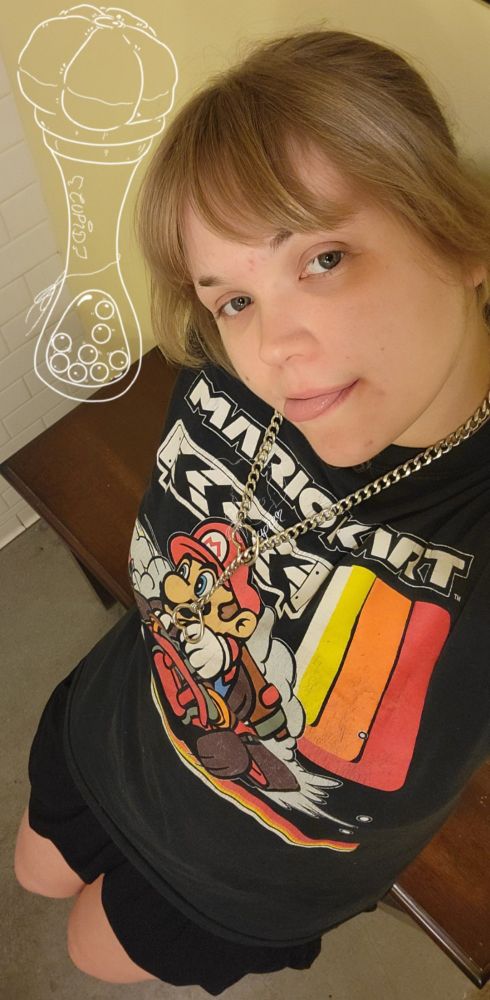 a picture of cupid, leaning against a cupboard while looking up at the camera