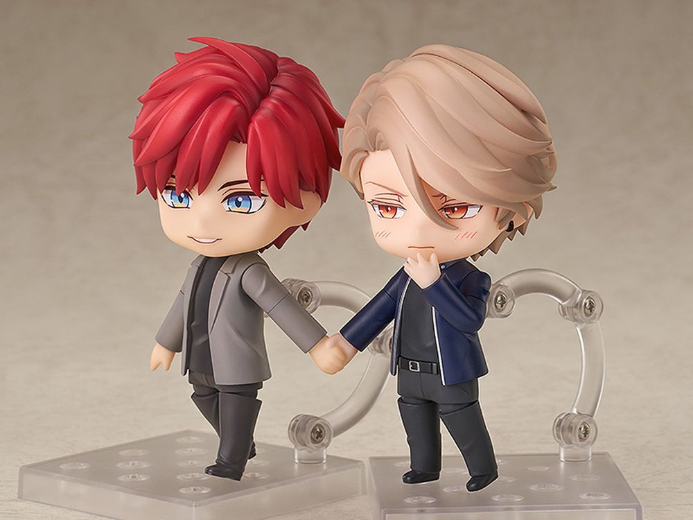 nendoroids (chibi anime figures) of Shizuma and Minato from Therapy Game, an 18+ yaoi manga. Shizuma has red hair and blue eyes, Minato has gold hair and eyes. they're holding hands!