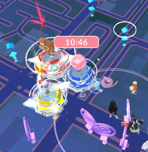 Pokemon GO - intersection with three gyms right next to each other, in all three different team colors.