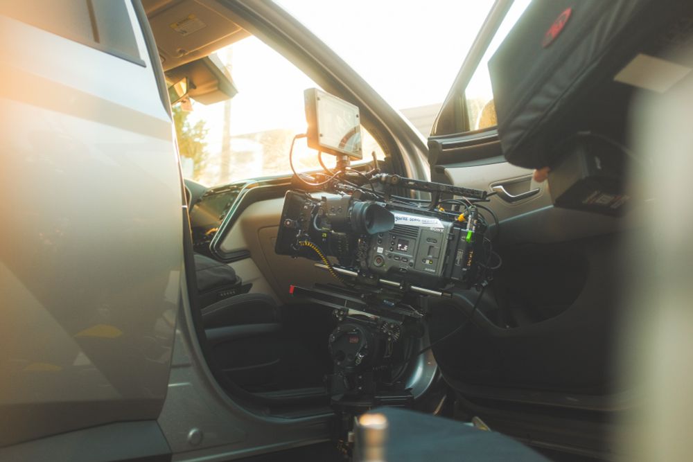 A camera sits looking up into a car