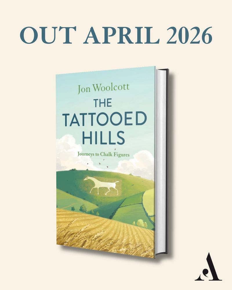 A book entitled The Tattooed Hills and showing a hillside chalk carving of a white horse 