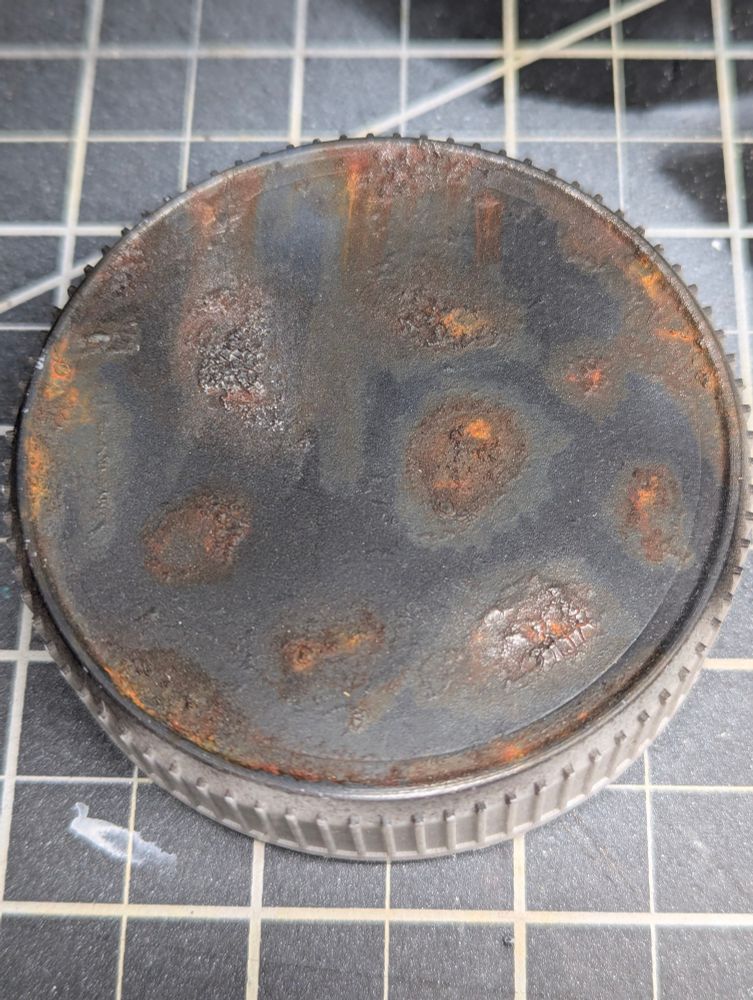 Peanut butter jar lid painted with crackle paint and oil paint weathering technique as practice.