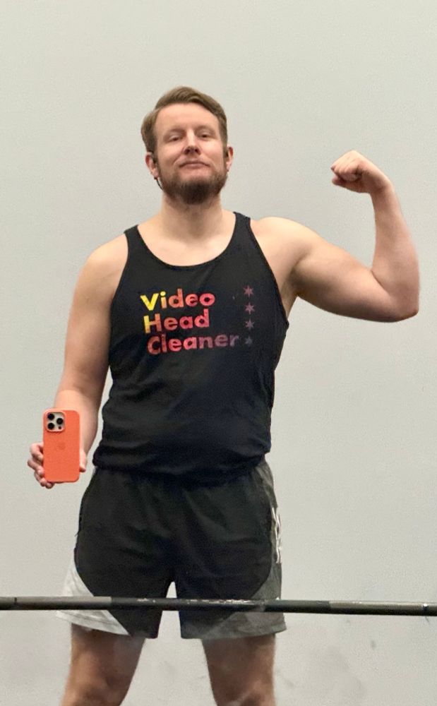 Flexing in the gym mirror mid deadlifts.