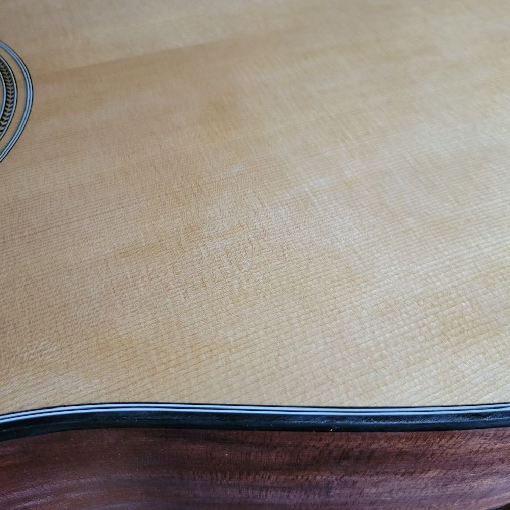 View of acoustic guitar top and side.