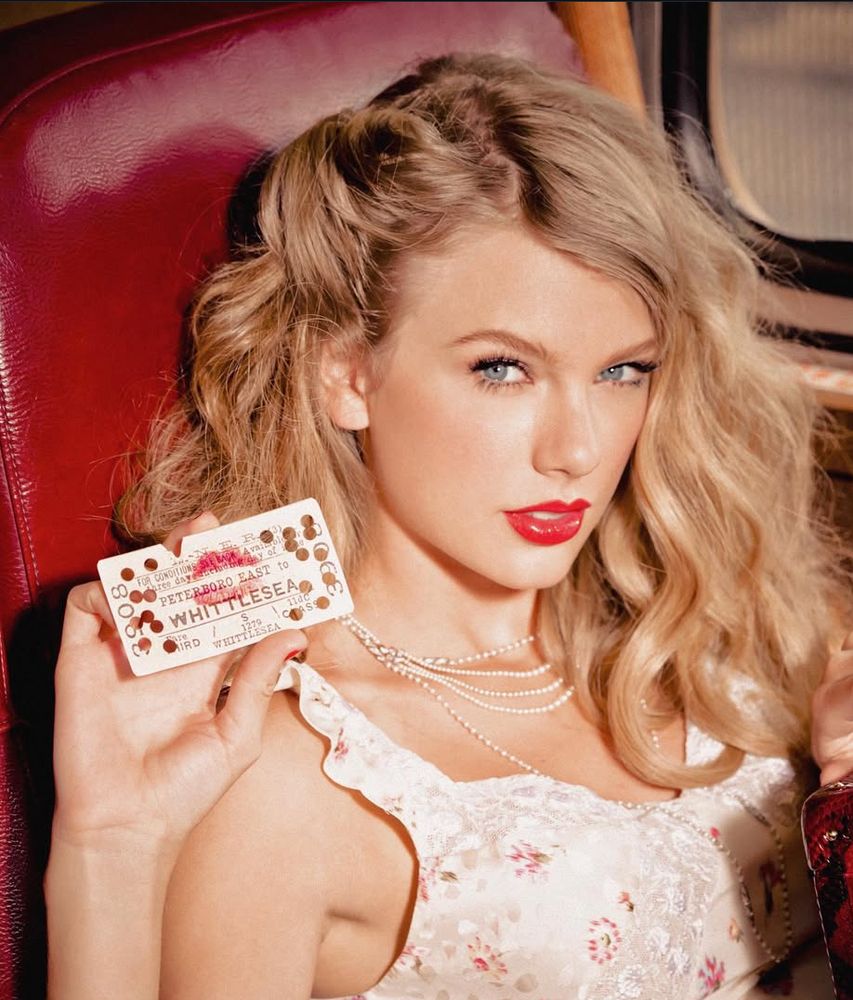 taylor holding up a card with a lipstick kiss mark on it