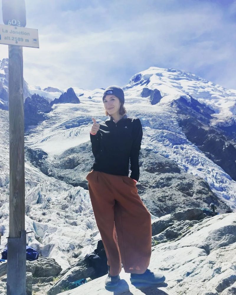 A picture of the original poster in front of a glacier, next to a sign that says "La Jonction alt. 2589m"