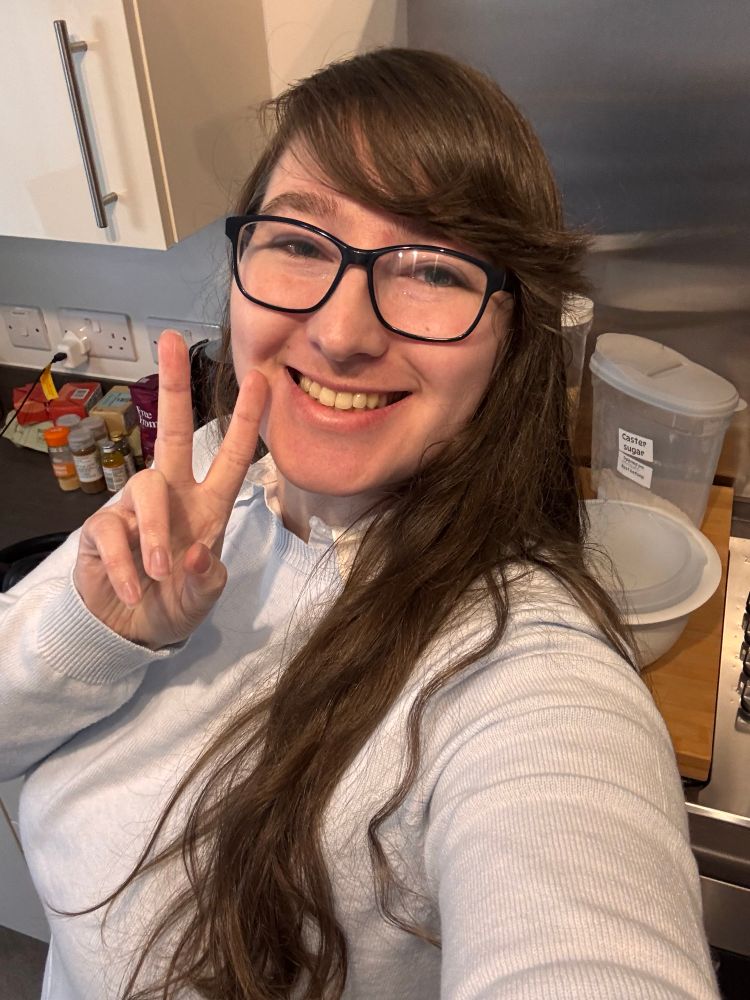 Me smiling with my hands in a peace sign