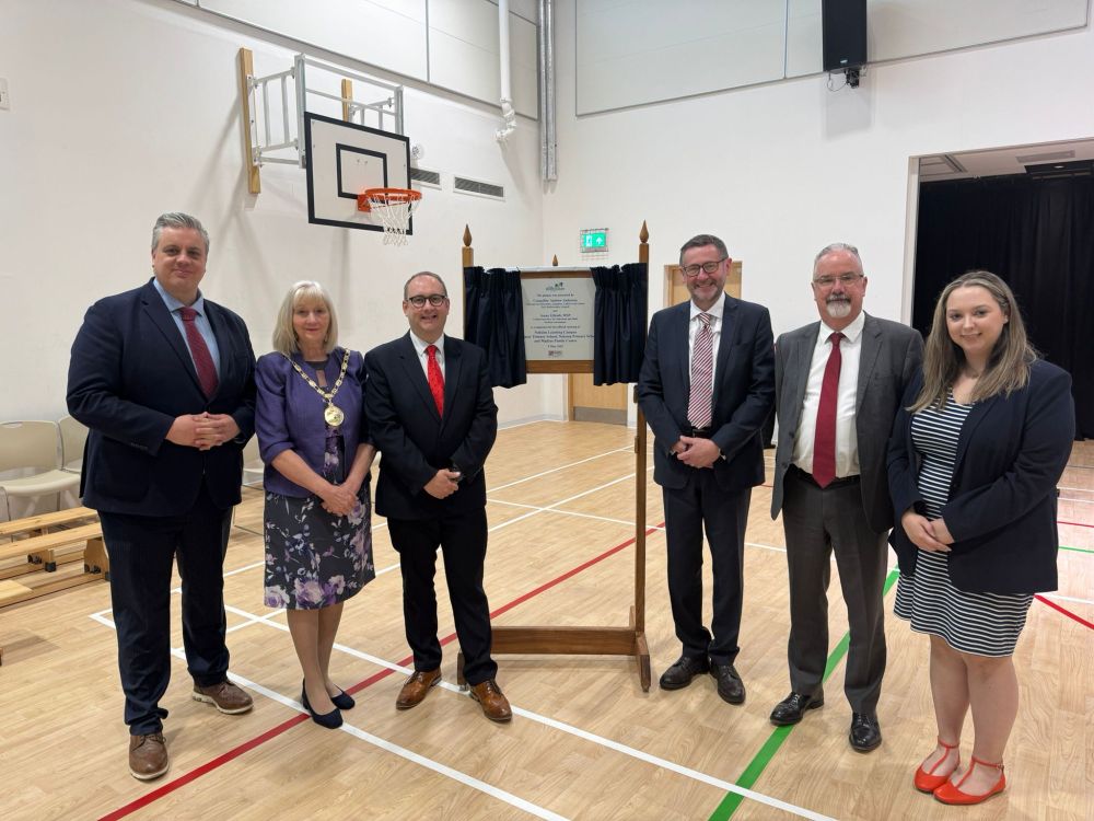 Photo of Paul O'Kane and politicians standing next to a plaque to commemorate the opening of the learning centre.  