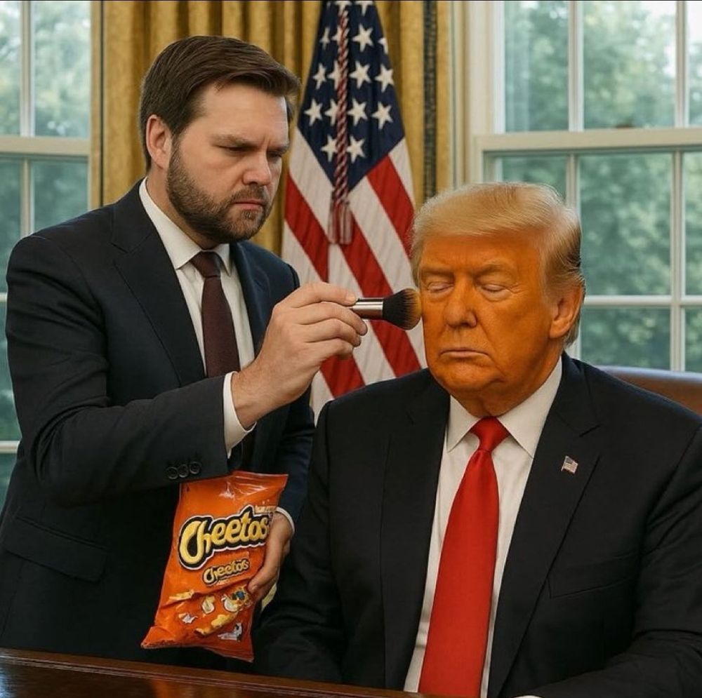 Vance is brushing orange Cheetos powder on Trump's face