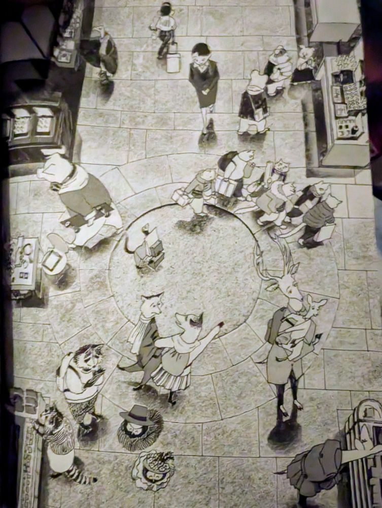 An overhead view of several animals passing through an open area of the store.