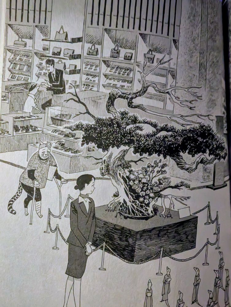 The concierge approaches a group of meerkats beholding a tree in the store.