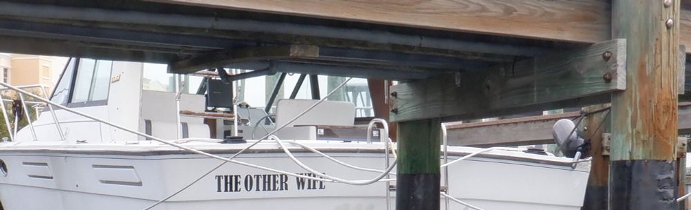 Photo of a docked boat that is named The Other Wife.
