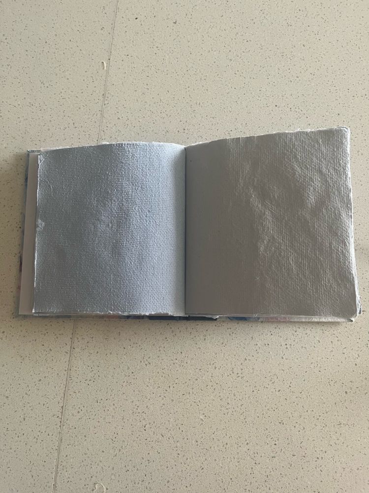 Shows the book open flat 