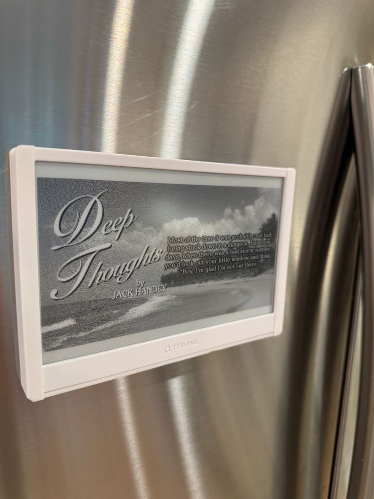An e-ink display in a magnetic frame on a refrigerator  door
