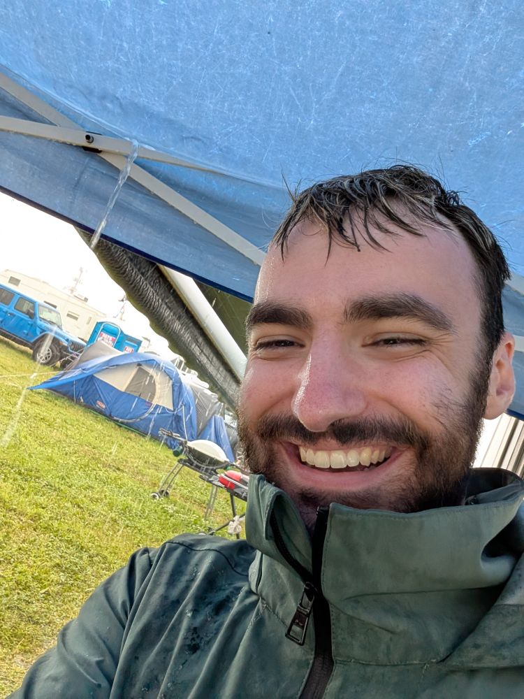 Soaked under an EZ-Up in a rain coat smiling my ass off 