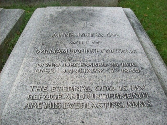 A recumbent tombstone – the text reads

Anne Louisa Ide
wife of
William Bourke Cockran

Born December 25 1876
Died January 7 1945

The eternal God is my
refuge and underneath
are his everlasting arms