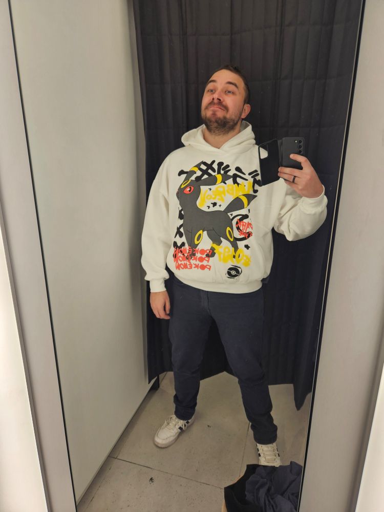 Me, a 30 year old white male, wearing a new hoodie with a Pokemon Umbreon in it, at the local shopping mall changing room.