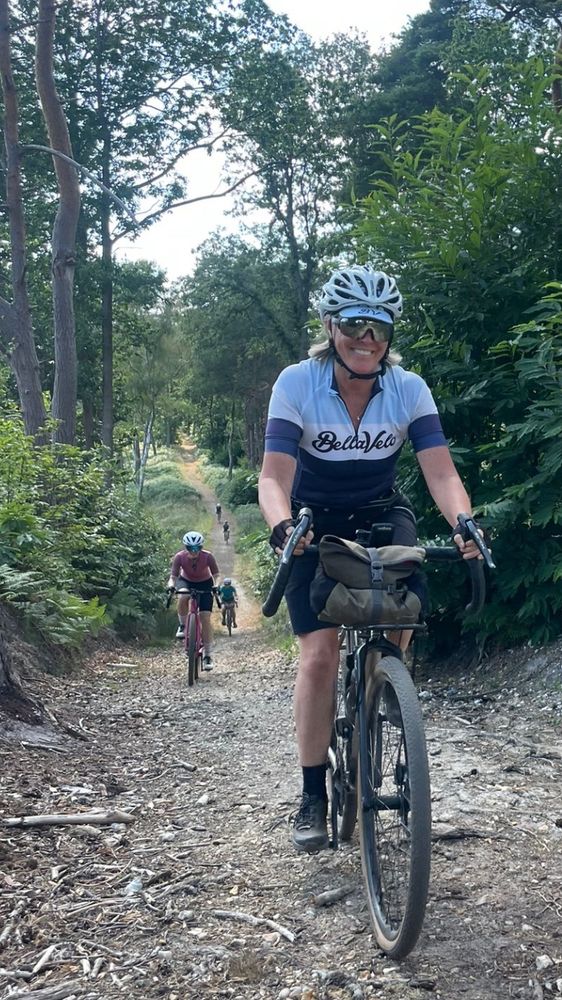 Me cycling through a forest smiling 
