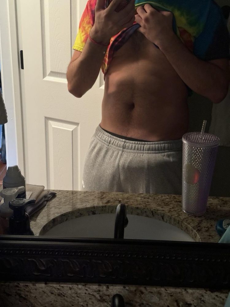 Chaos standing next to his water bottle showing his evening pjs
