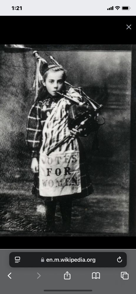 Little girl piper wearing suffragette banner. Poignant. She played the bagpipes so imprisoned suffragettes could hear the support and be comforted