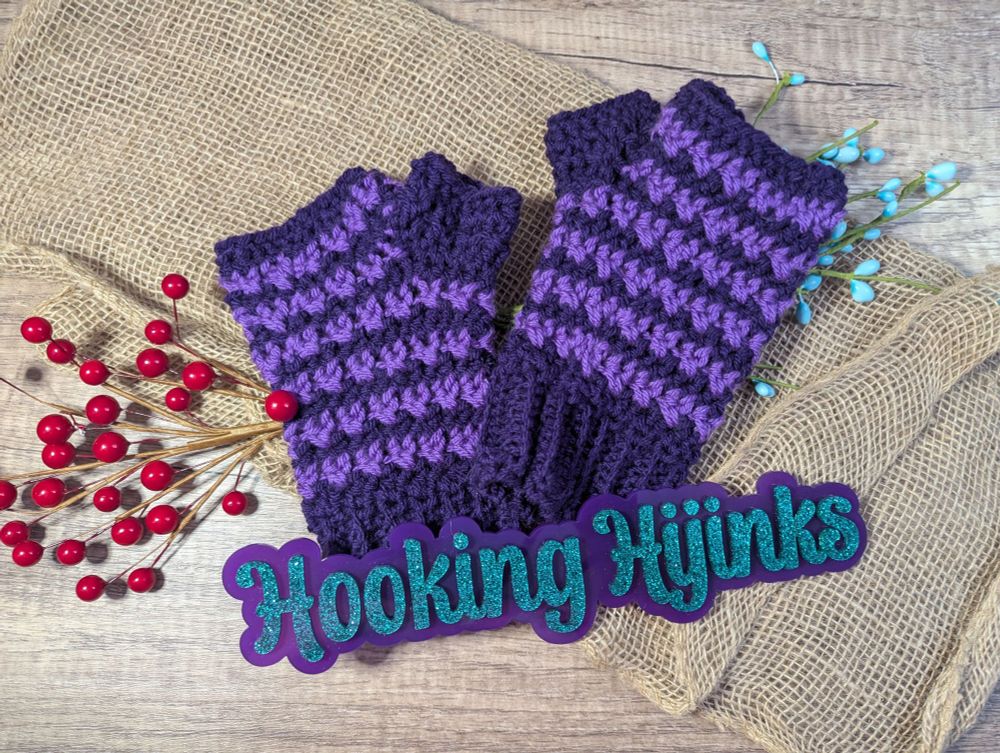 a picture of crocheted fingerless mitts. they are in two shades of purple