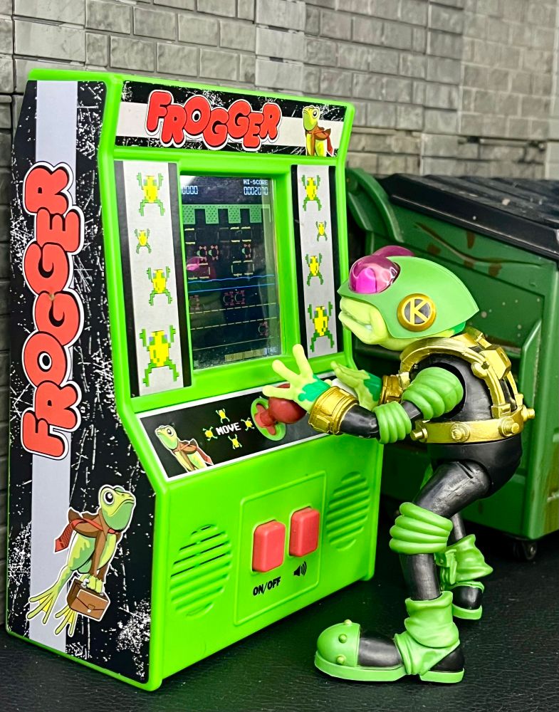 Boss Fight Studios Bucky O’Hare Storm Toad Trooper playing a mini Frogger arcade cabinet.