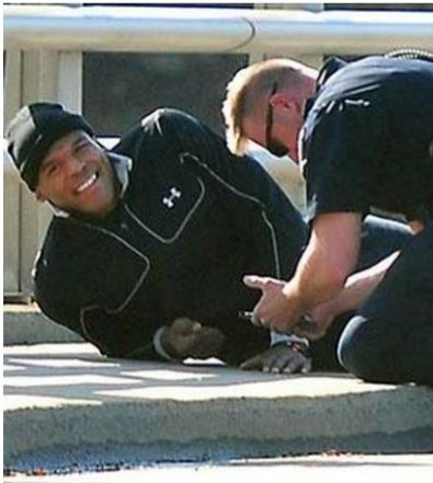 Cam Newton in Under Armor (#sponsored) laying on the ground smiling after having survived a car accident