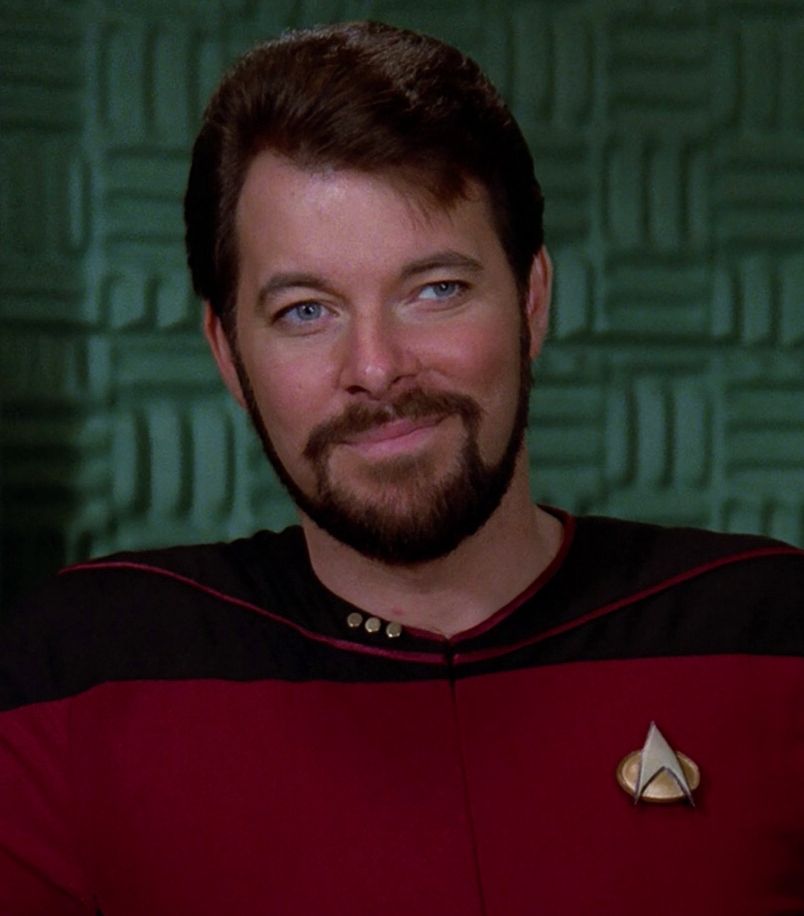 Commander Riker giving a very sly smile.