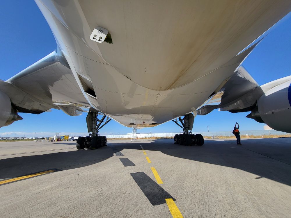 The underside of a 777-200 with a human for scale.