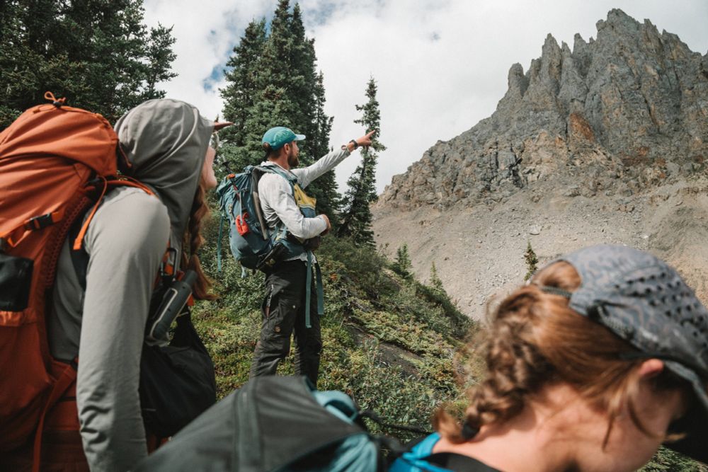 Justin Strauss treks with postdoctoral scholar Meghan King and college sophomore Caroline Nadalin to a fossilized reef.